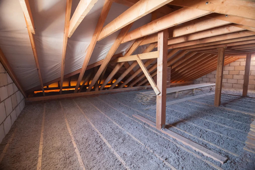 Blown-in cellulose insulation covering an attic floor